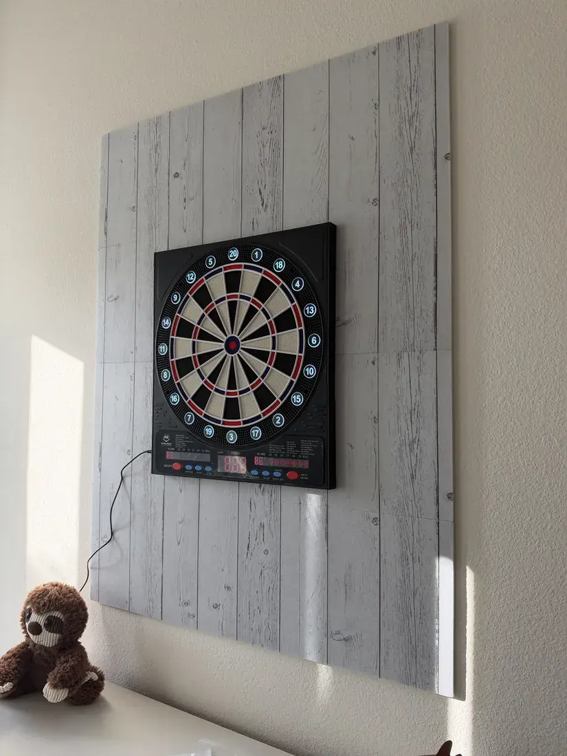 Electronic dartboard mounted on a panel wall in Newport Beach, October 2026