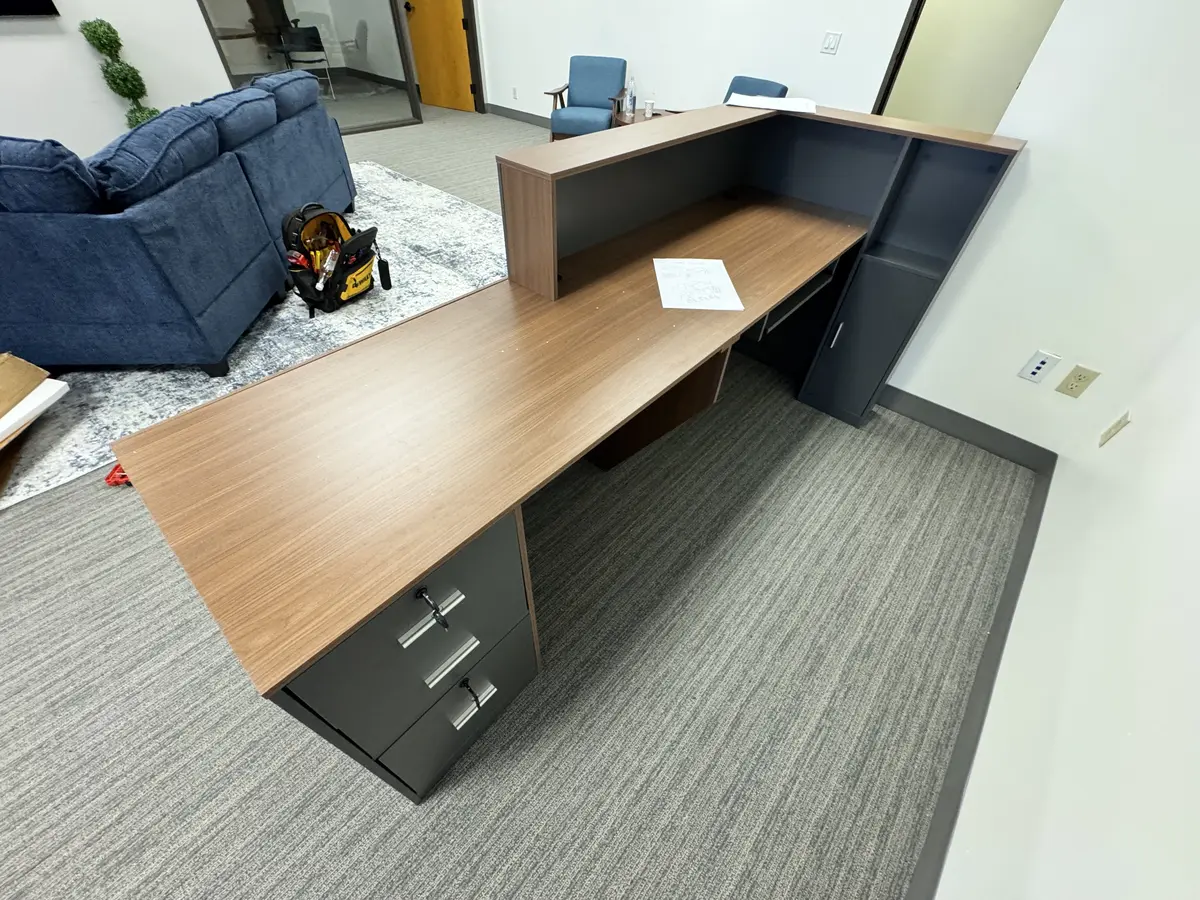 L-shaped reception desk assembled for an Orange County office