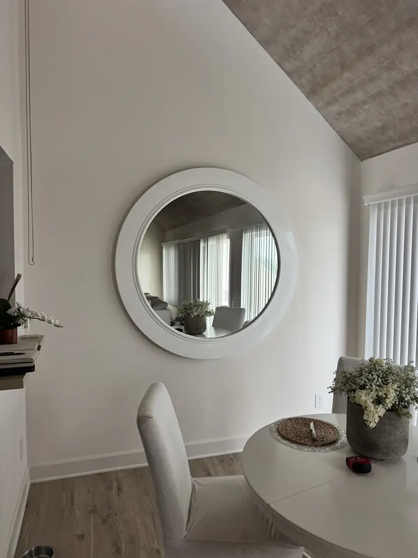 Round wall mirror hung in Orange County