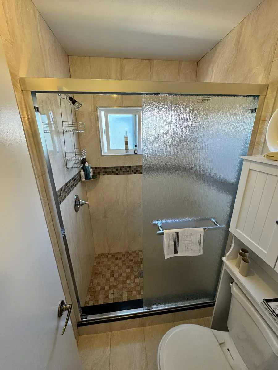Frameless shower sliding door installed in Orange County