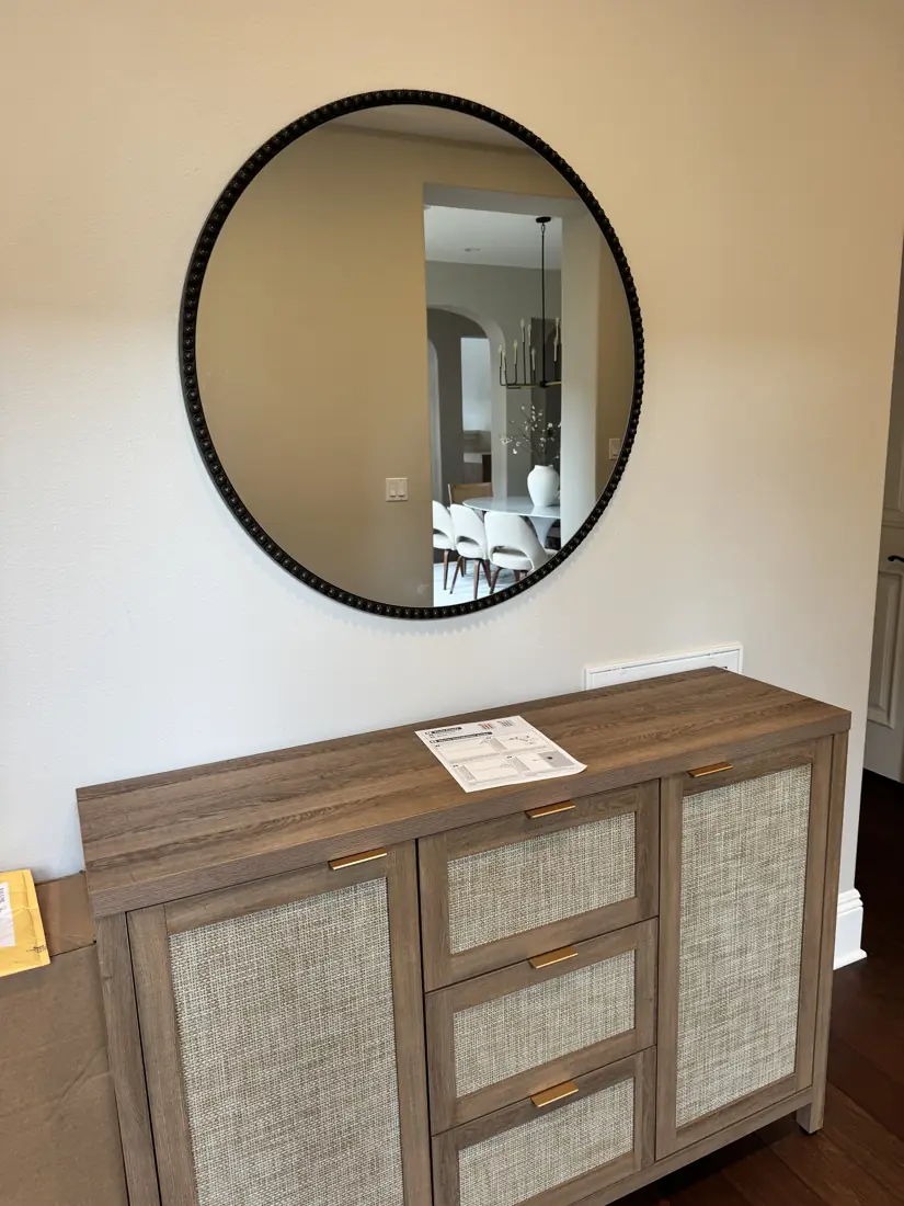 Sideboard assembled and round mirror hung in Orange County