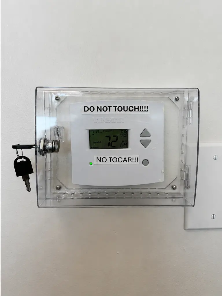 Thermostat with locked protective cover installed, Orange County