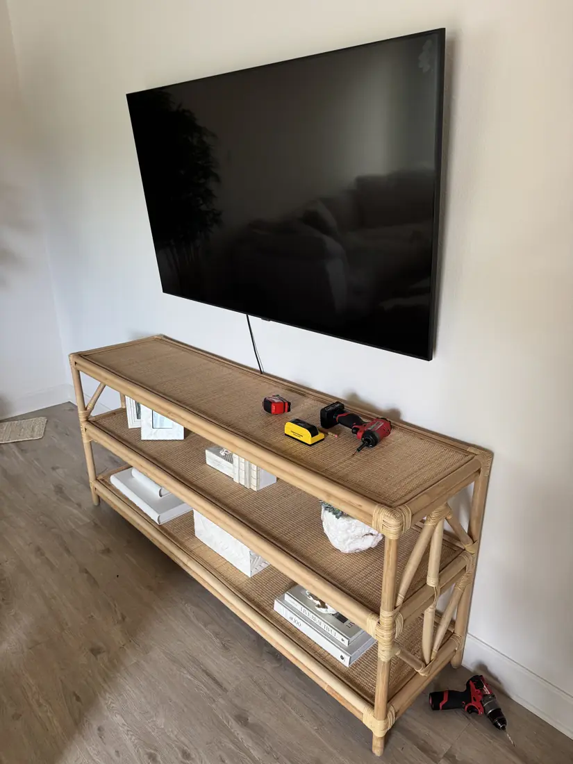 TV wall-mounted above a rattan console in Orange County